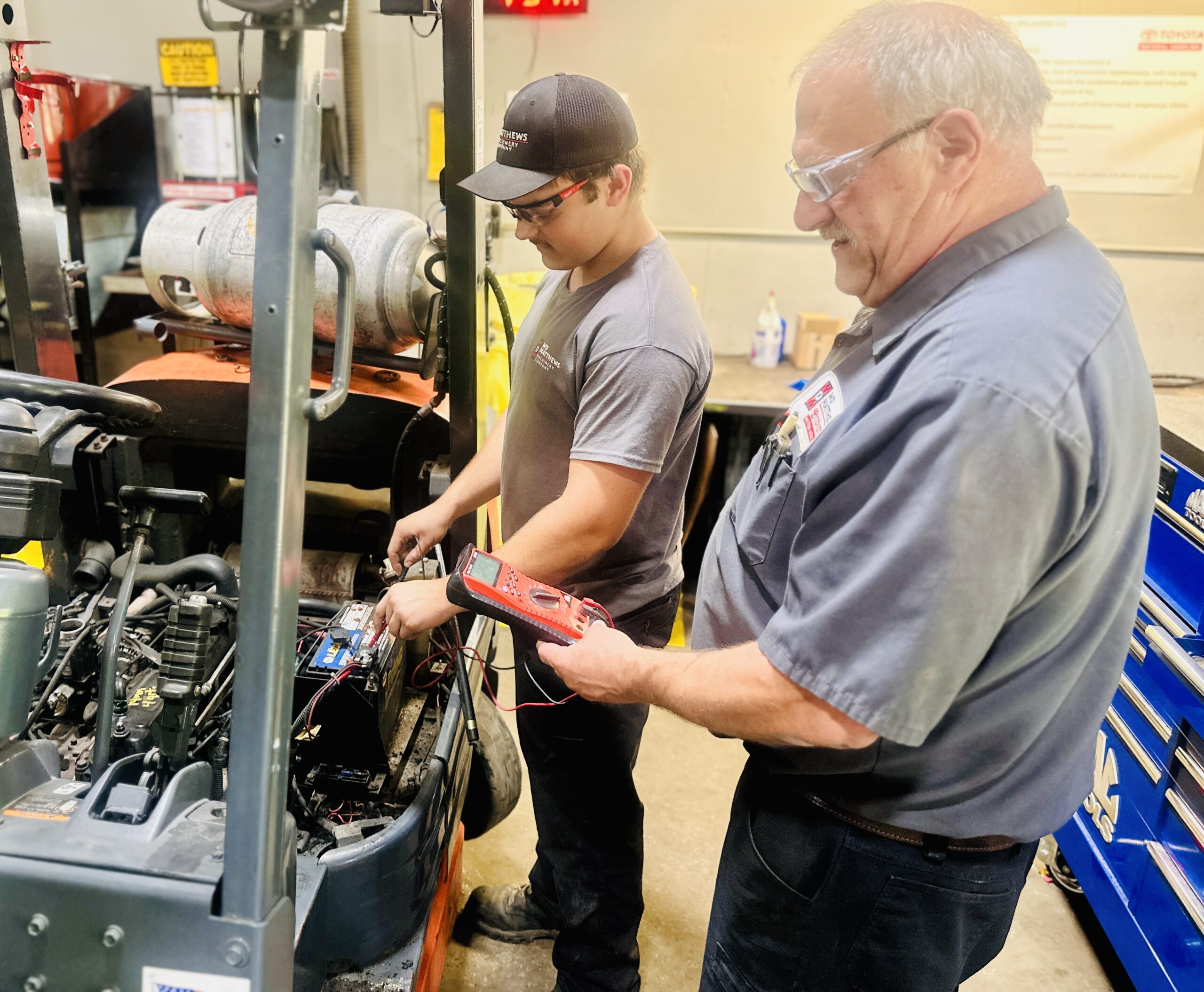 “Grandfather and grandson technicians at W.D. Matthews Machinery, representing generational legacy in skilled trades.”